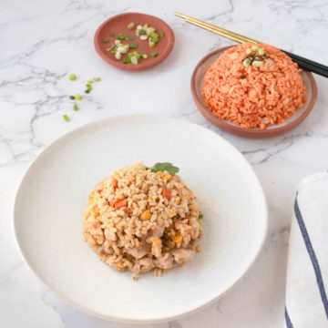 An assortment of various fried rice dishes on a dining table.