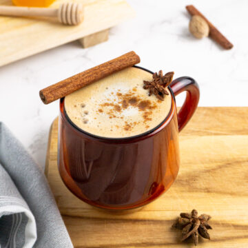 A cup of healthy chai latte topped with spices.