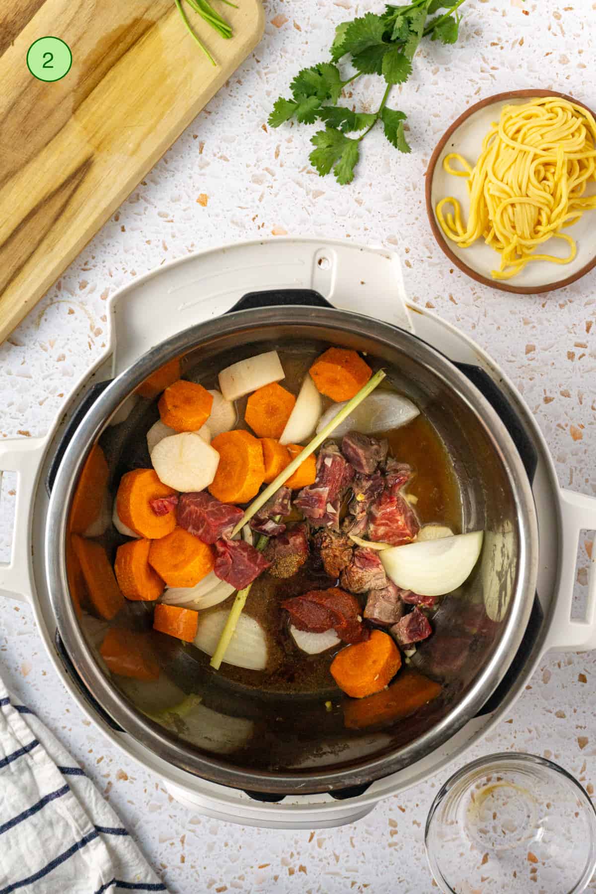 Add the root vegetables and beef in the instant pot to prepare for pressure cooking.