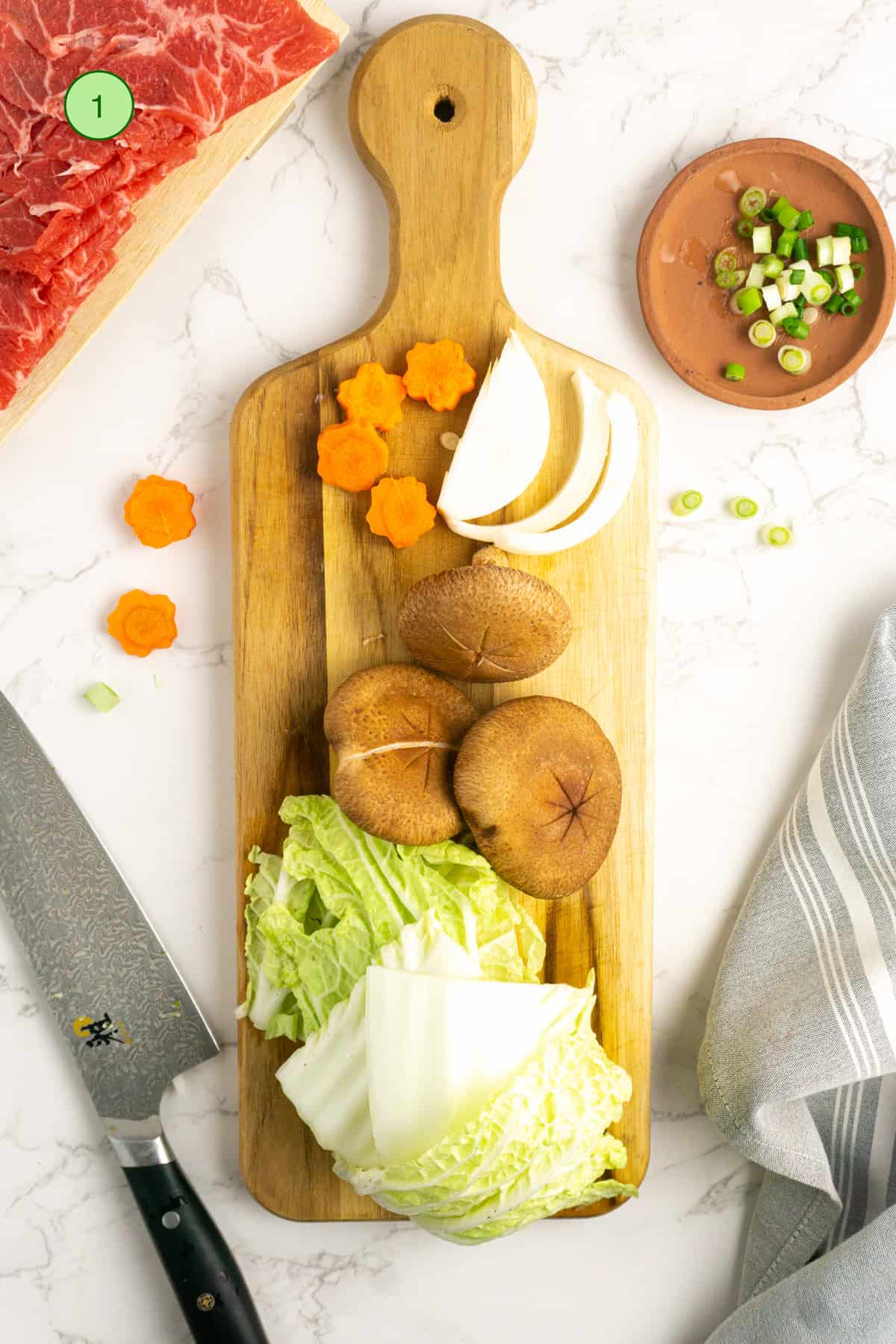 Preparing the vegetables on a wooden cutting board.