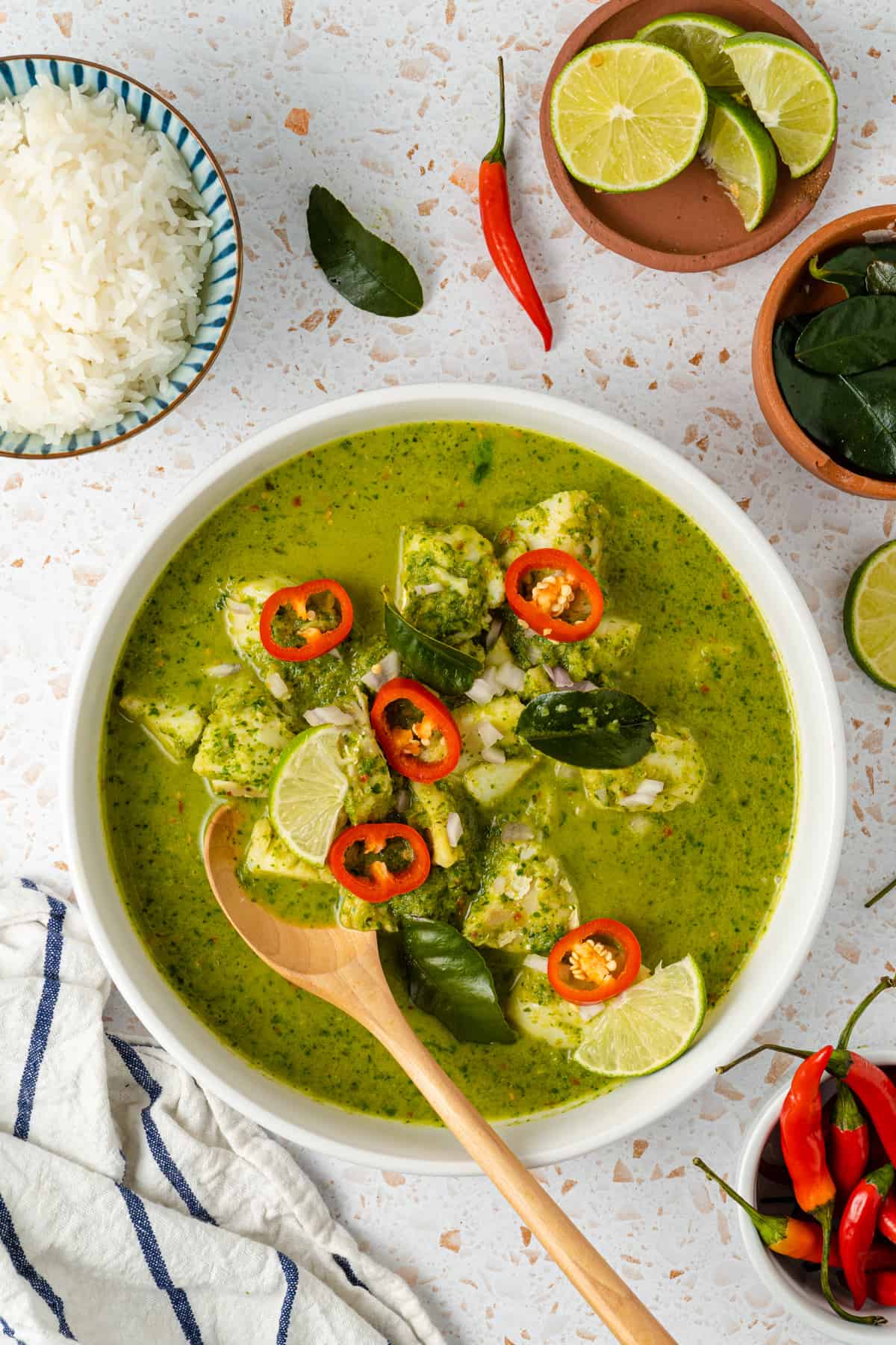 An overhead shot of Thai green fish curry with rice on the side.