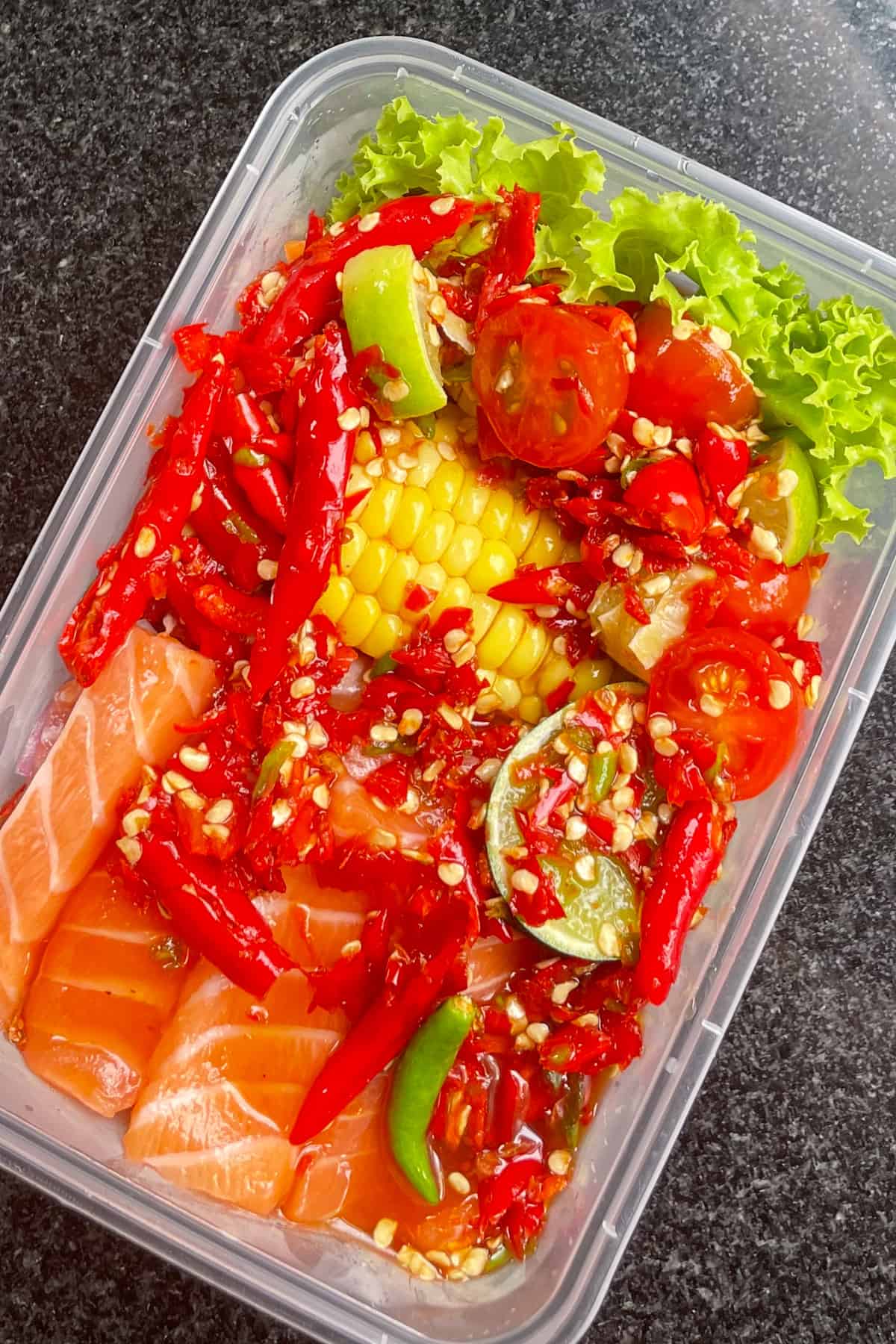 A tray of salmon laab with corn and chilies.