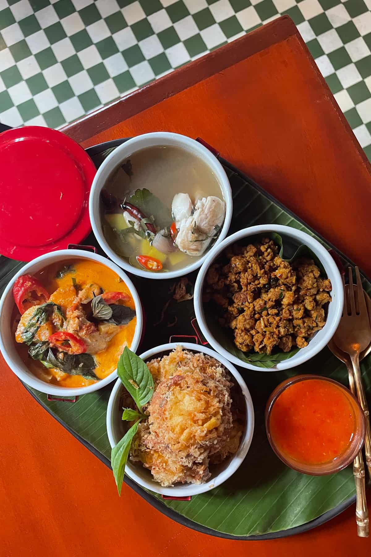 An assortment of healthy Thai dishes on a tray.