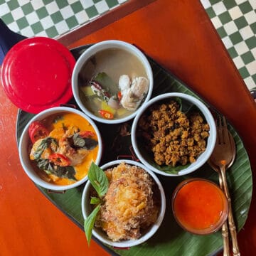 An assortment of healthy Thai dishes on a tray.