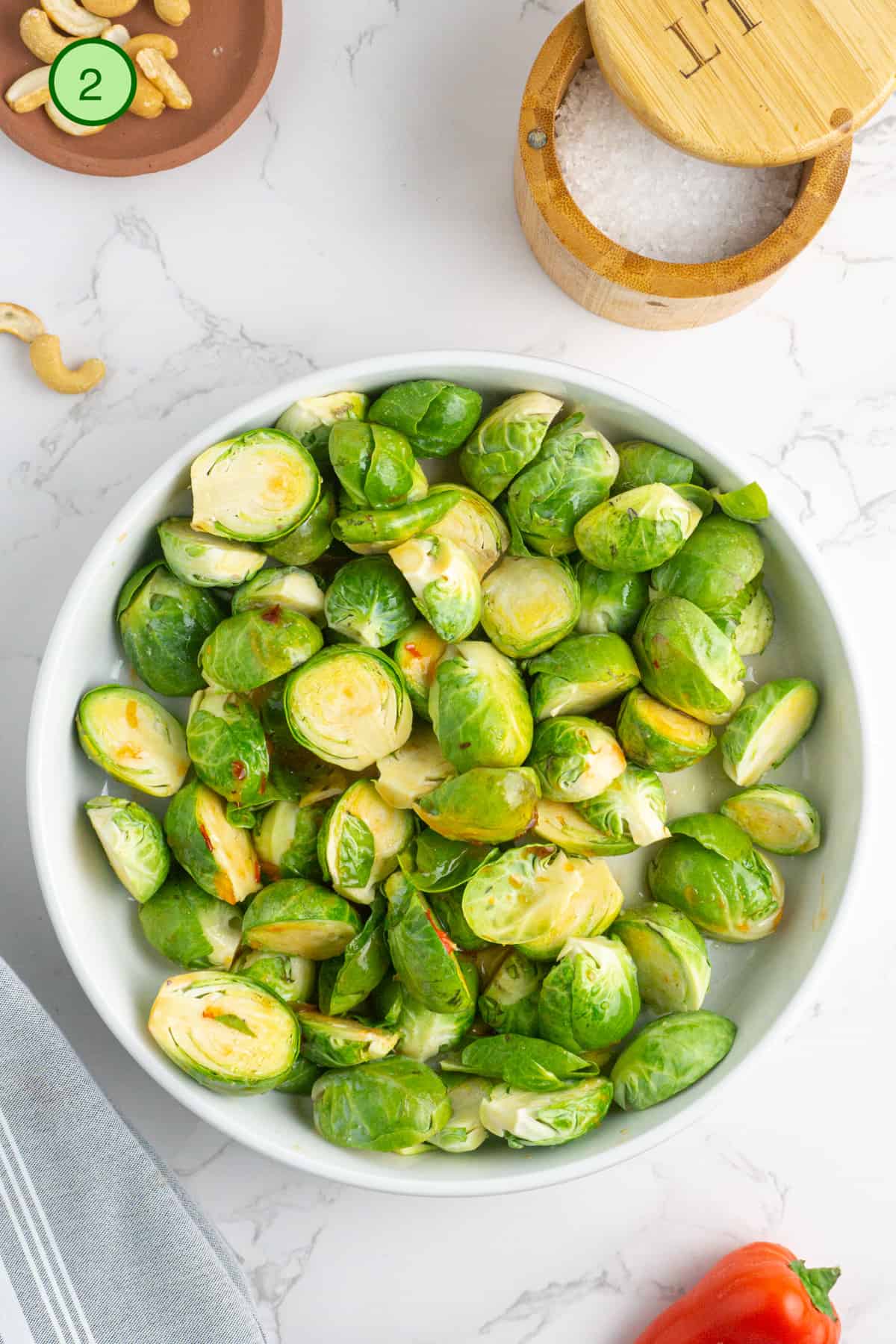 Season the brussels sprouts in a bowl.