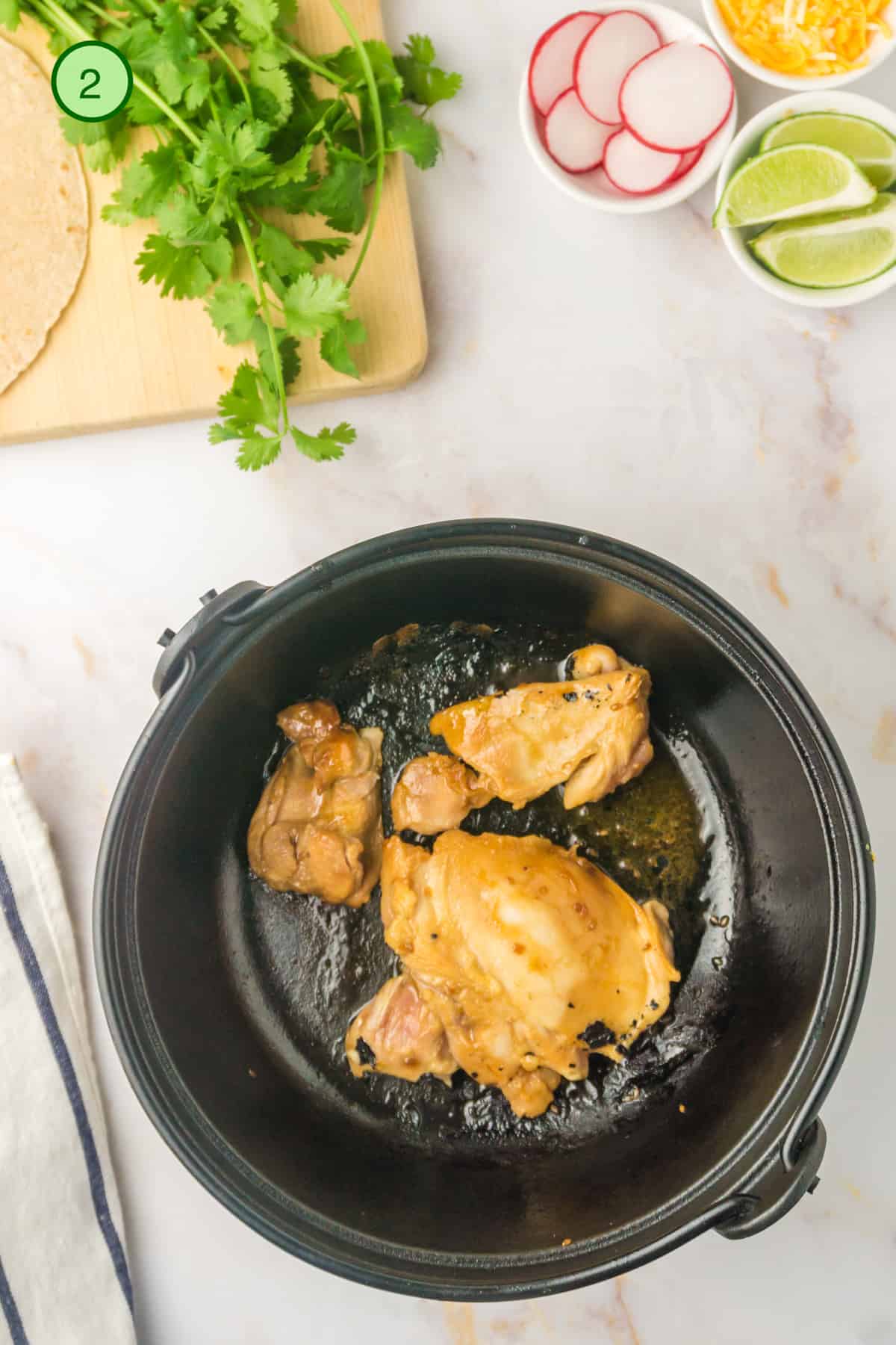 Cooking the chicken in a cast iron skillet.