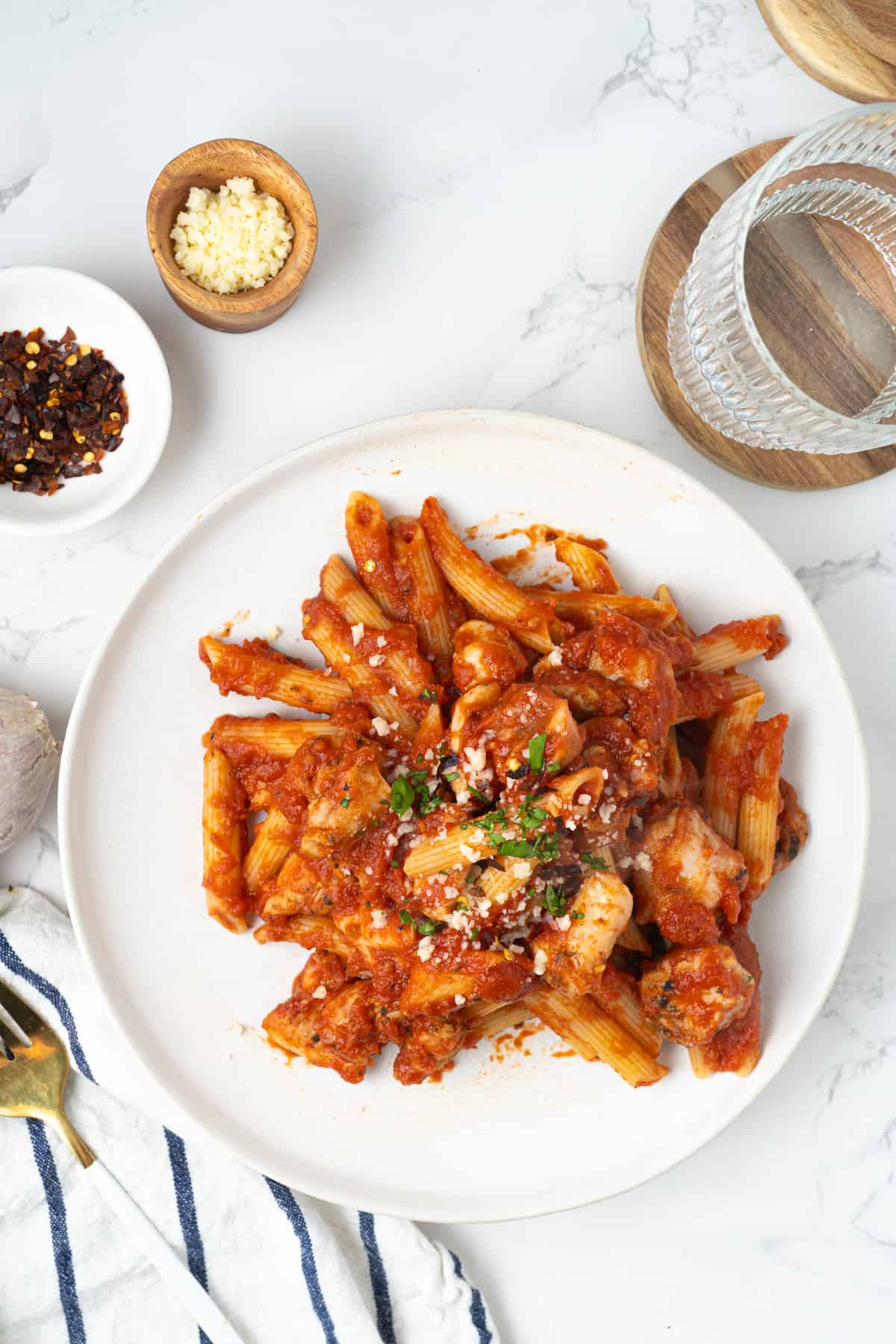 Chicken arrabiata with penne with cheese and red pepper flakes.