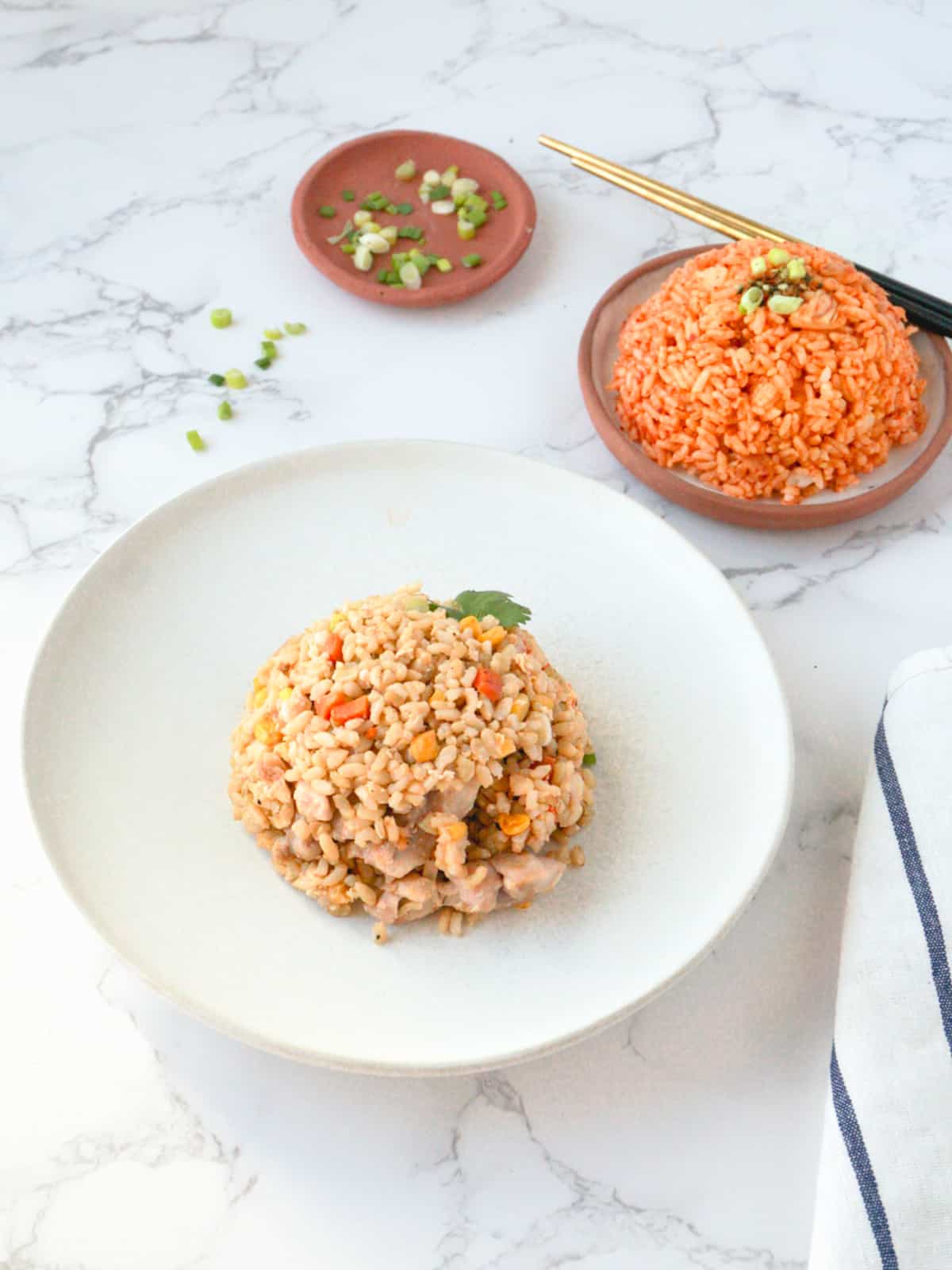An assortment of various fried rice dishes on a dining table.