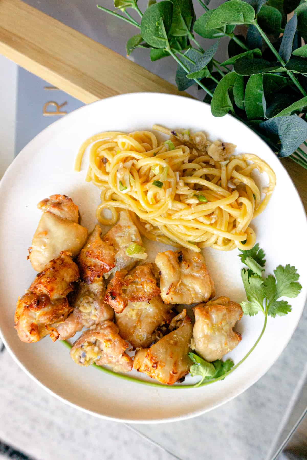 A plate of lemongrass chicken with garlic noodles.